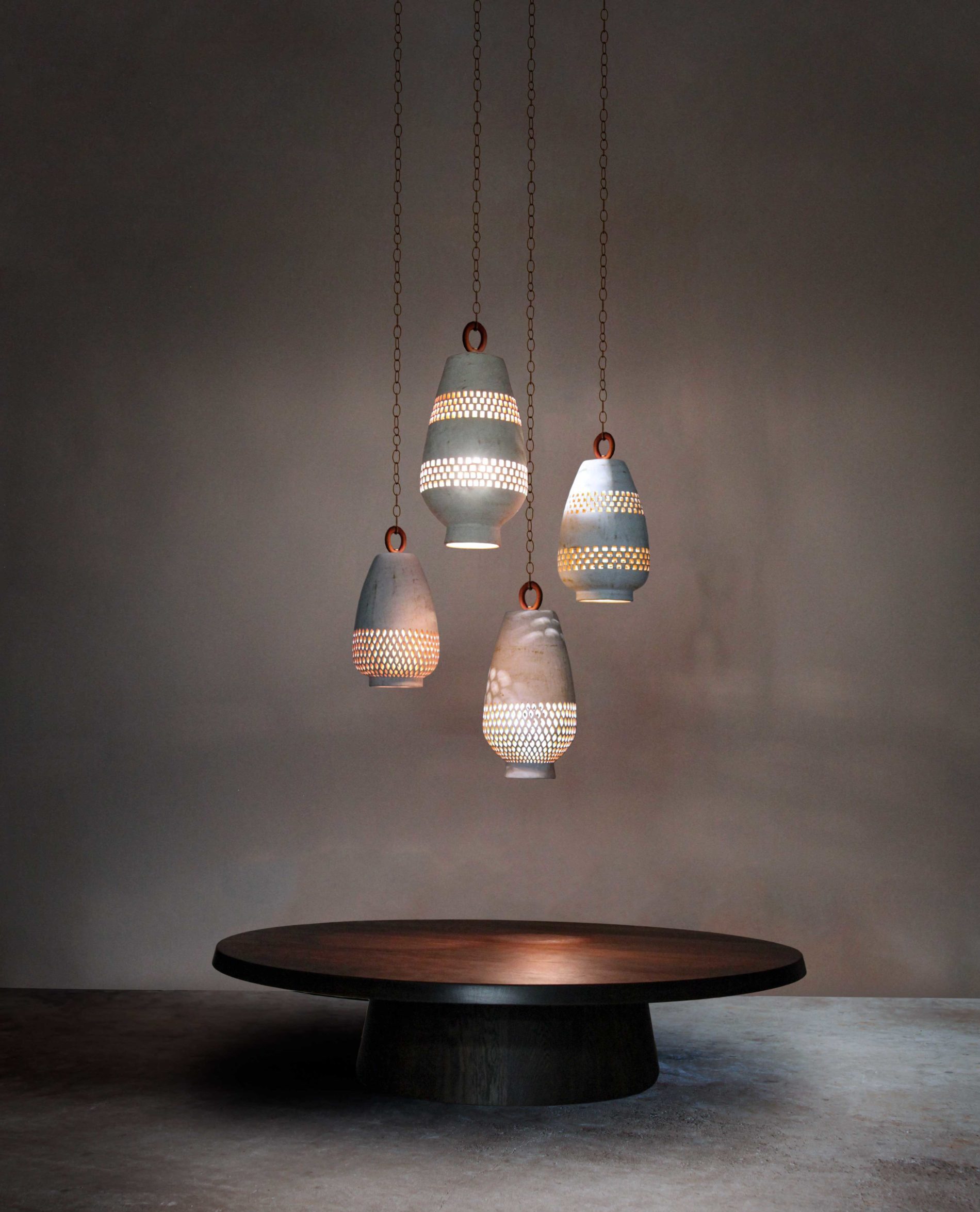 Atzompa-Lighting_Hero-BlackCreekMercantile-table_lit White ceramic pendant lights with geometric cutouts