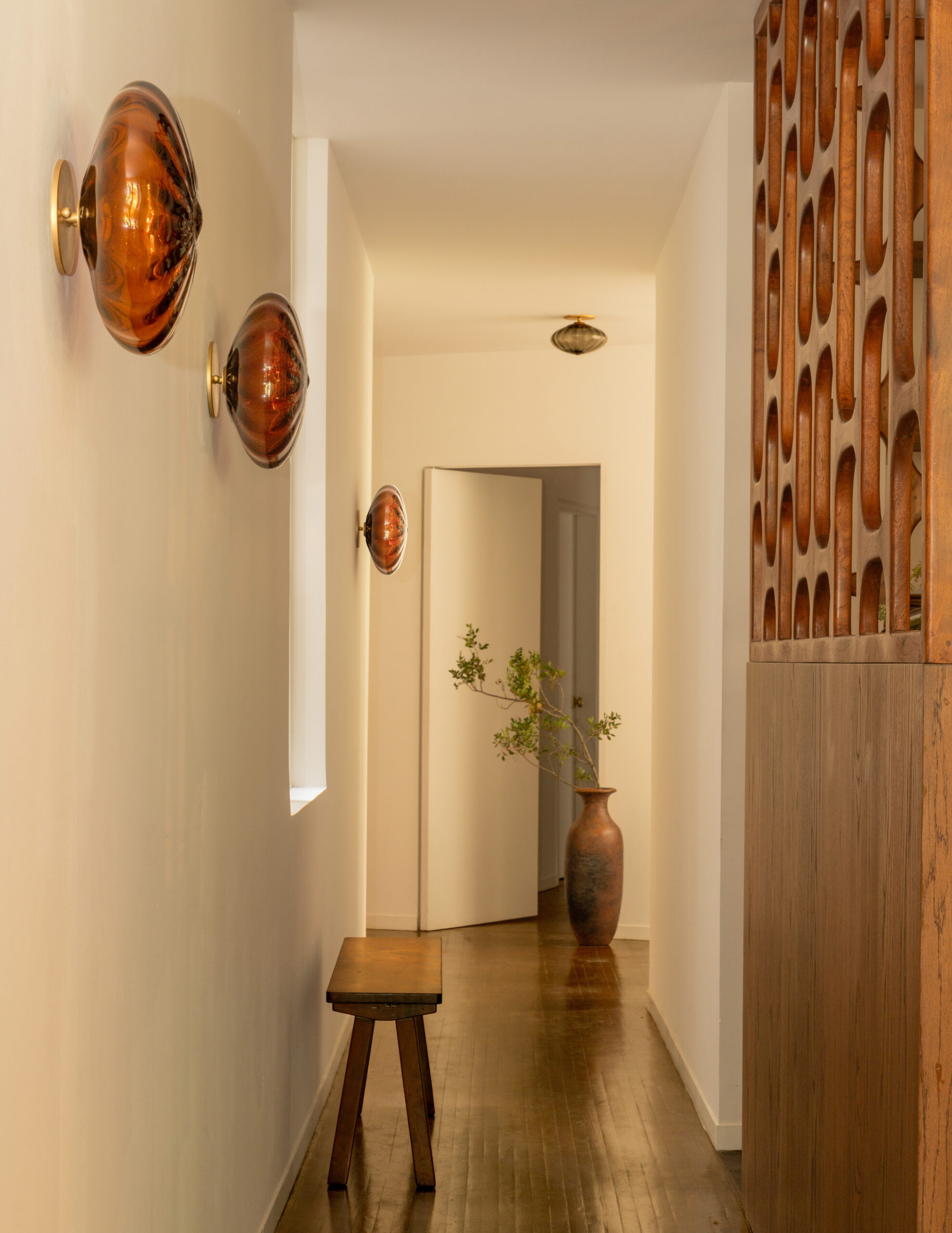 CDMX studio with Espadín sconces down the hallway
